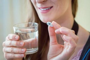 Female-client-takes-capsule-endoscopy-pill-for-diagnostic-testing