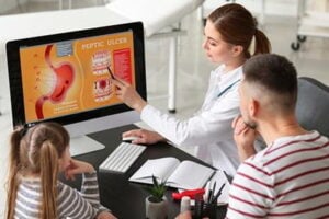 Doctor-discusses-digestive-health-with-patient-accompanied-by-child