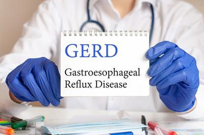 Heroimage0058177001738765106 Doctor-Holding-Notepad-with-GERD-Notes