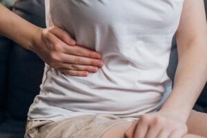 Person holding side with gallstone pain
