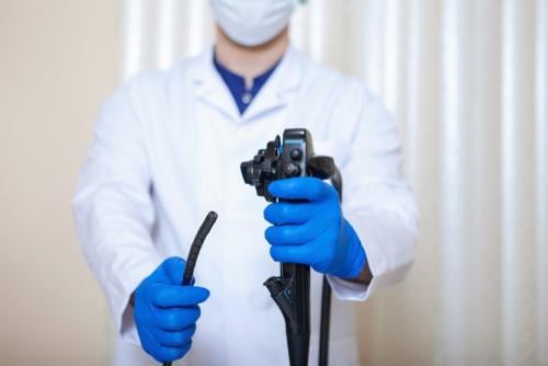 Heroimage0506926001776952055 Doctor holding colonoscope in clinical setting